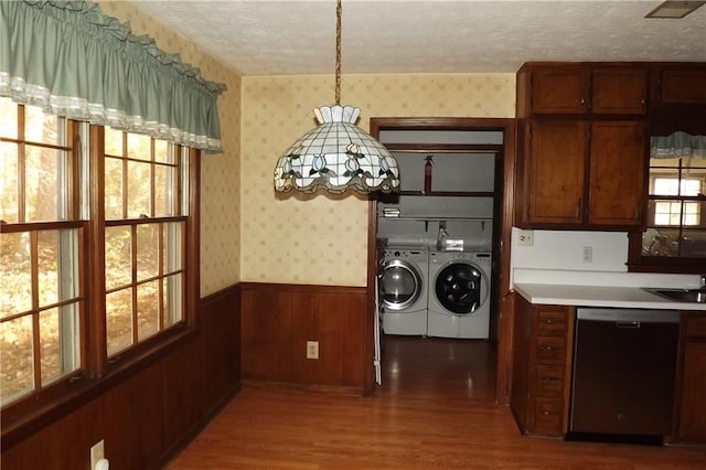 interior space featuring washer and clothes dryer, plenty of natural light, a textured ceiling, and hardwood / wood-style flooring