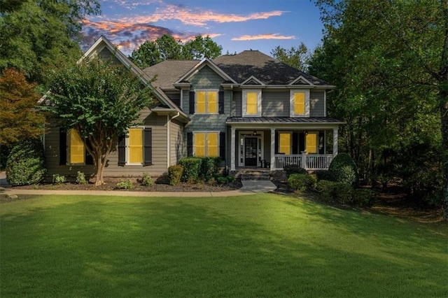 view of front facade with a porch and a yard