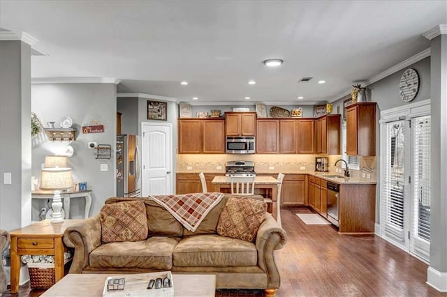 living room with dark wood-type flooring, ornamental molding, and sink