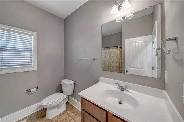 bathroom featuring vanity, tile patterned flooring, and toilet