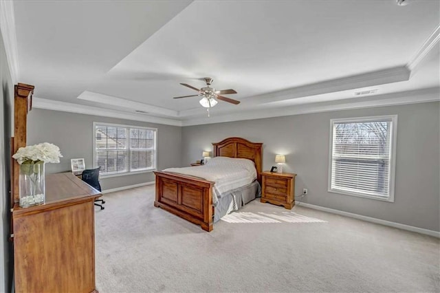 carpeted bedroom with multiple windows, ornamental molding, a raised ceiling, and ceiling fan