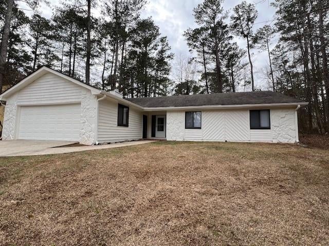 single story home featuring a garage and a front lawn