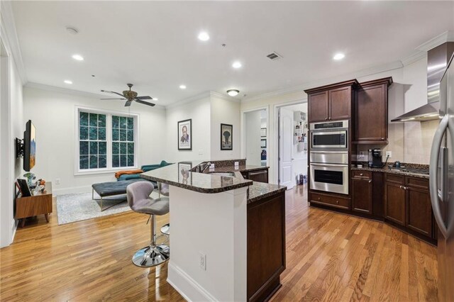 3280 Stillhouse Ln SE Unit 212, Atlanta, GA 30339 - unfurnished living room featuring decorative columns, wood-type flooring, a warm lit fireplace, ornamental molding, and baseboards