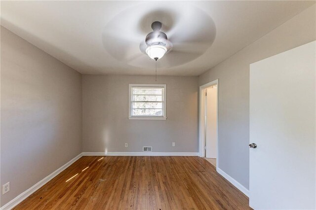 spare room with ceiling fan and hardwood / wood-style floors