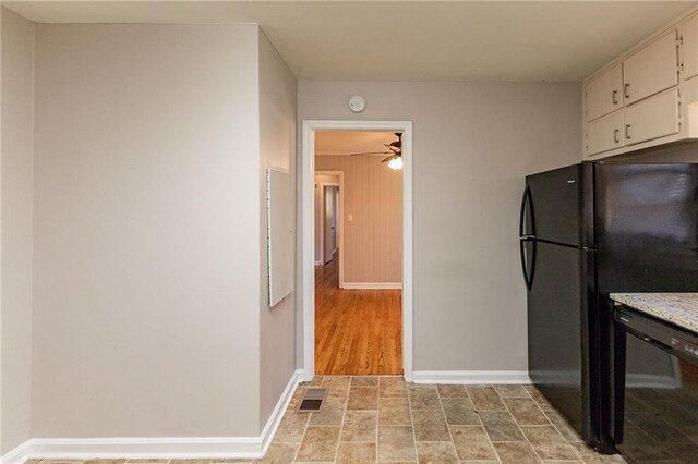 kitchen featuring white cabinets, light wood-type flooring, ceiling fan, and black appliances