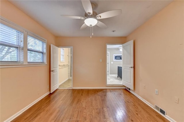 spare room with light hardwood / wood-style floors and ceiling fan