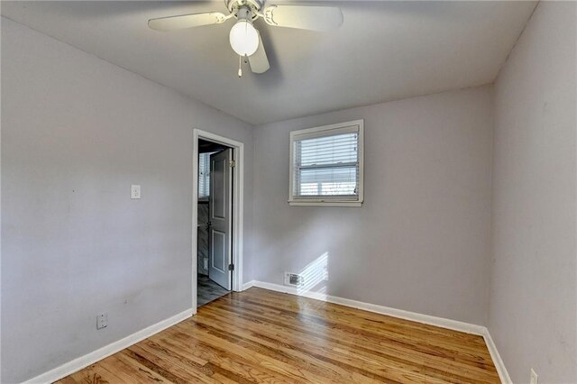 unfurnished bedroom featuring ceiling fan, light hardwood / wood-style floors, and a closet