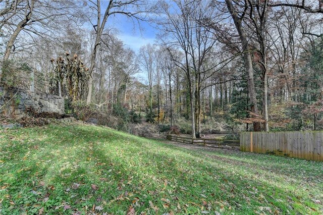 back of property featuring a yard and a deck