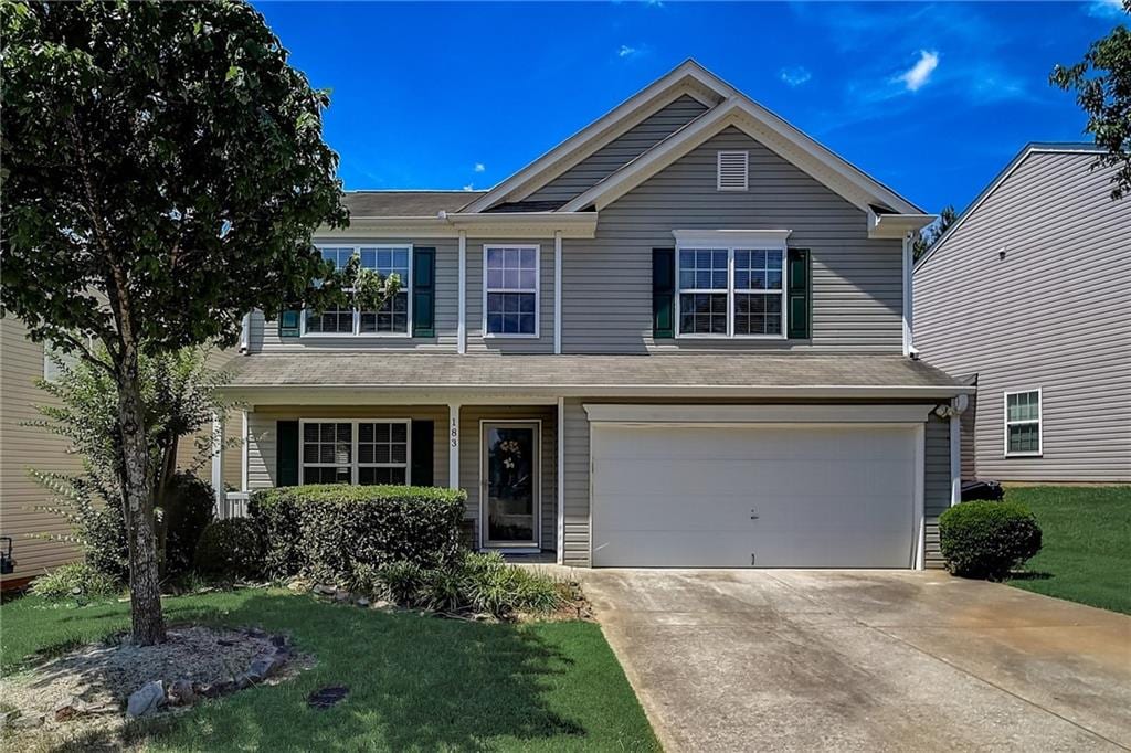 view of front of home featuring a garage and a front lawn