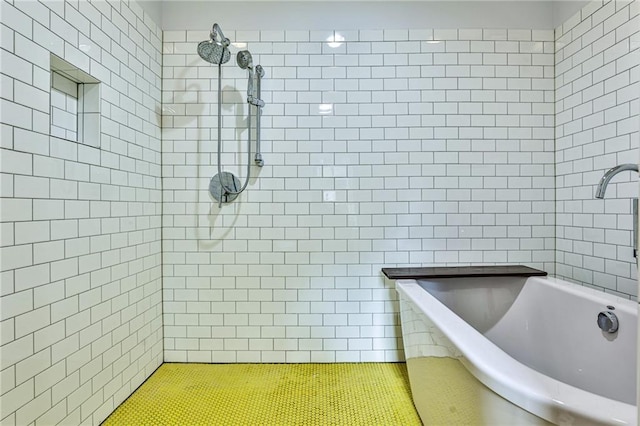 bathroom with tile patterned floors and shower with separate bathtub