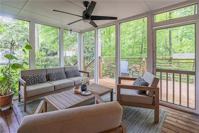 sunroom with ceiling fan and outdoor lounge area