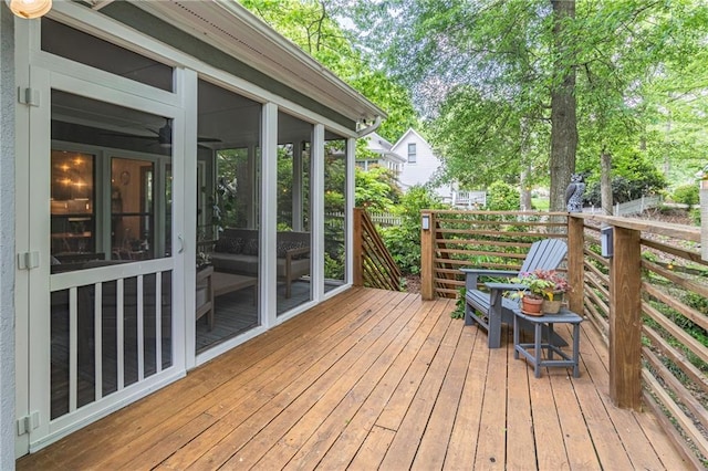 wooden deck with a sunroom