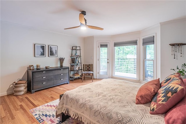 bedroom featuring access to outside, a ceiling fan, baseboards, light wood-type flooring, and ornamental molding