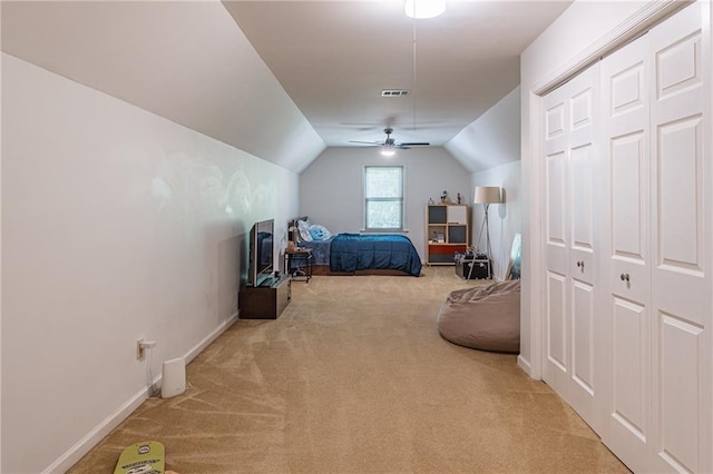 carpeted bedroom featuring a ceiling fan, baseboards, vaulted ceiling, and visible vents