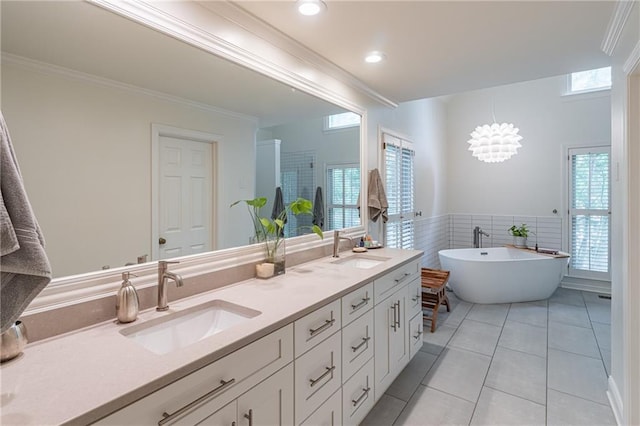 full bath featuring a sink, tile patterned flooring, double vanity, and a freestanding bath