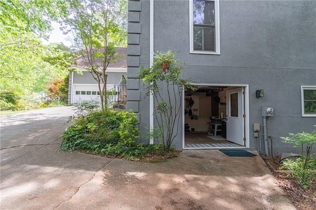 view of property exterior with a garage and stucco siding