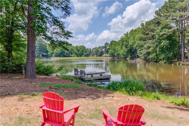 dock area with a water view and a wooded view
