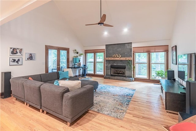 living room featuring french doors, a ceiling fan, high vaulted ceiling, and a healthy amount of sunlight