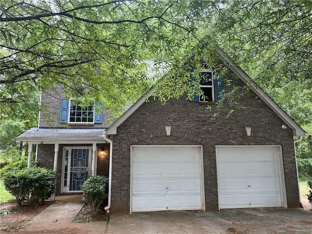 traditional home featuring a garage, concrete driveway, and brick siding