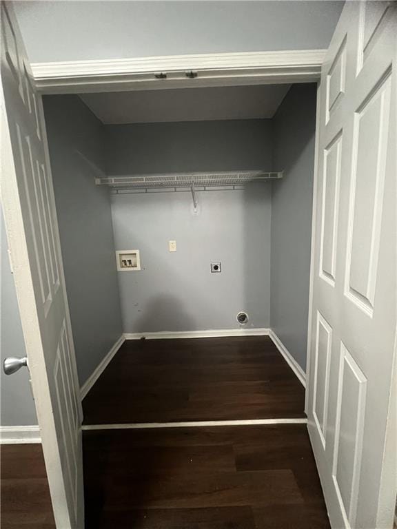 washroom with hookup for a washing machine, wood finished floors, and baseboards