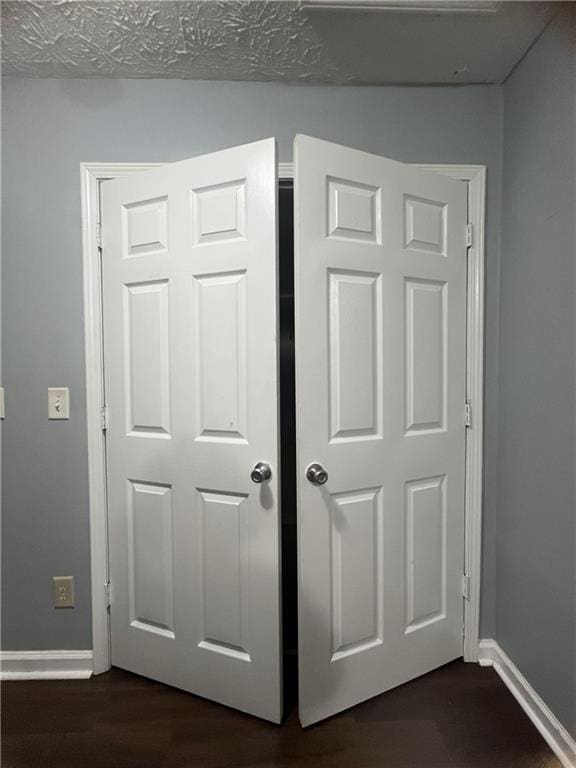 detailed view of baseboards and wood finished floors