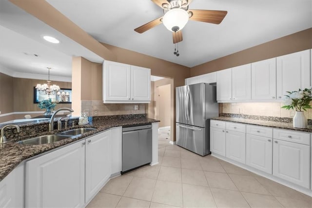 3334 Peachtree Rd NE Unit 608, Atlanta, GA 30326 - kitchen featuring stainless steel appliances, a sink, tasteful backsplash, a chandelier, and white cabinets