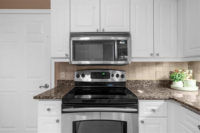3334 Peachtree Rd NE Unit 608, Atlanta, GA 30326 - kitchen featuring stainless steel appliances, white cabinets, backsplash, and dark stone counters