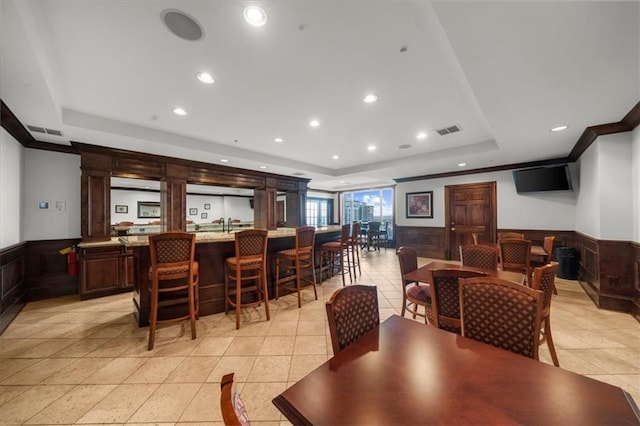3334 Peachtree Rd NE Unit 608, Atlanta, GA 30326 - dining room featuring a tray ceiling, wainscoting, recessed lighting, light tile patterned floors, and crown molding
