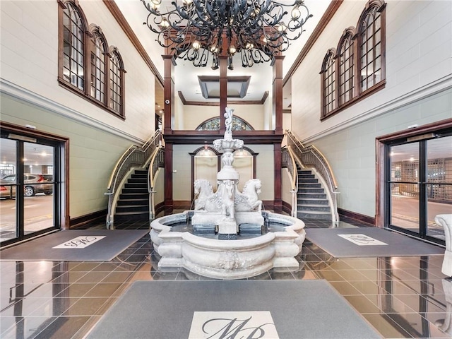 3334 Peachtree Rd NE Unit 608, Atlanta, GA 30326 - entrance foyer featuring a chandelier, stairway, ornamental molding, baseboards, and a towering ceiling