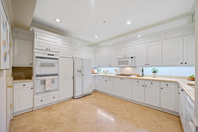 tiled dining space featuring crown molding, a tray ceiling, decorative columns, and a notable chandelier