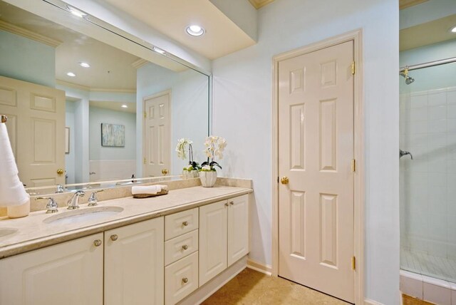 bedroom with ornamental molding, light colored carpet, and a tray ceiling