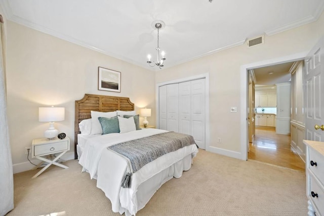 carpeted bedroom featuring ornamental molding and a chandelier