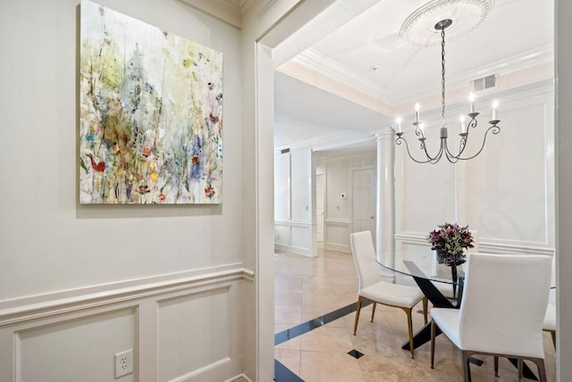 living room featuring built in shelves, crown molding, and a notable chandelier