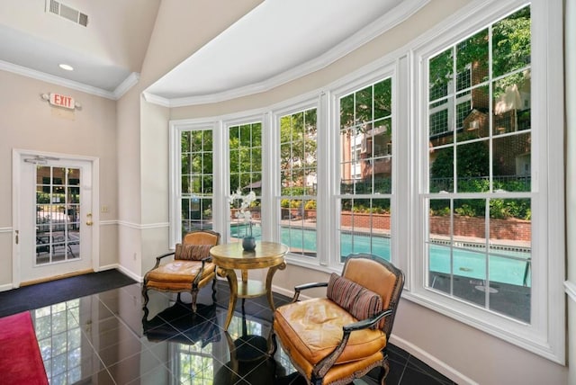 tiled living room with ornamental molding and high vaulted ceiling