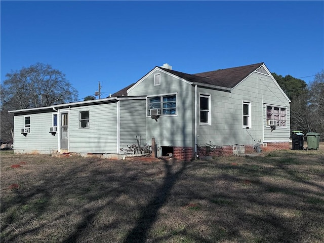 back of property featuring a lawn