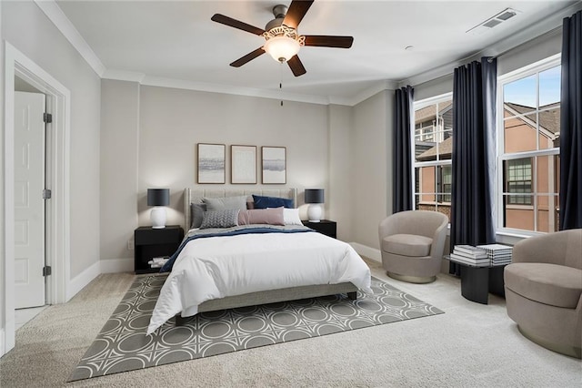 bedroom featuring ceiling fan, light colored carpet, and crown molding