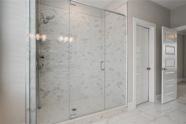 bathroom featuring a shower with shower door