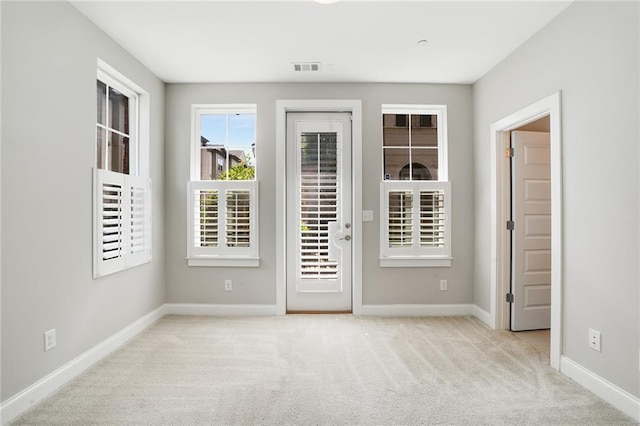 empty room featuring light colored carpet