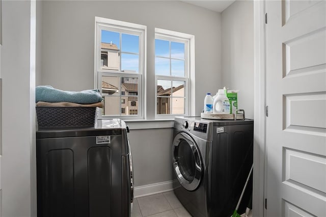 washroom with independent washer and dryer and light tile patterned flooring