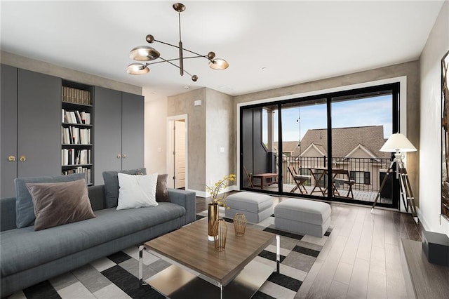 living room with a chandelier and dark wood-type flooring