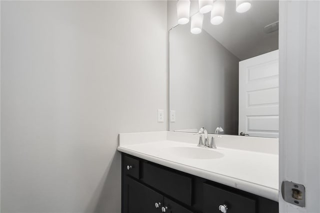 bathroom with vanity and lofted ceiling