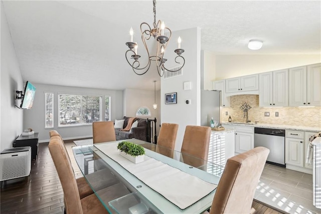 10475 Willow Meadow Cir, Alpharetta, GA 30022 - dining space featuring lofted ceiling, a chandelier, and light wood-style floors