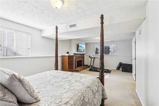10475 Willow Meadow Cir, Alpharetta, GA 30022 - bedroom with carpet flooring, a textured ceiling, and a fireplace