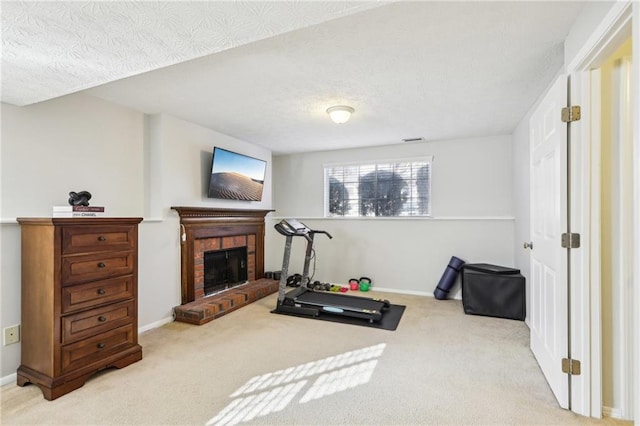10475 Willow Meadow Cir, Alpharetta, GA 30022 - workout room featuring carpet flooring, a brick fireplace, and a textured ceiling