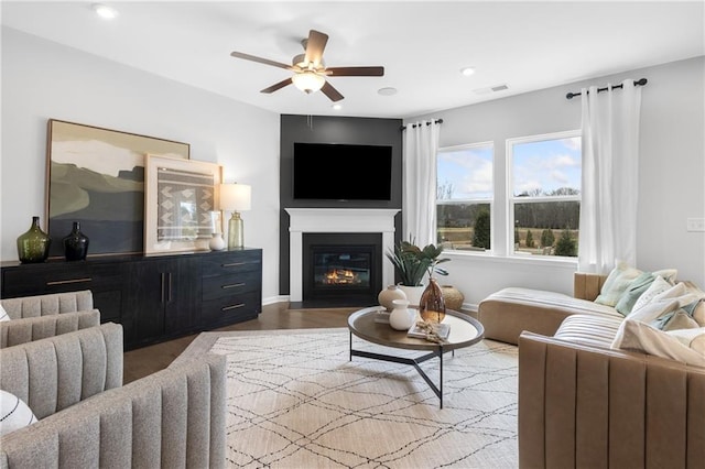 living room with ceiling fan and light hardwood / wood-style flooring