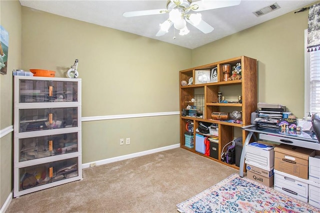 carpeted office featuring ceiling fan