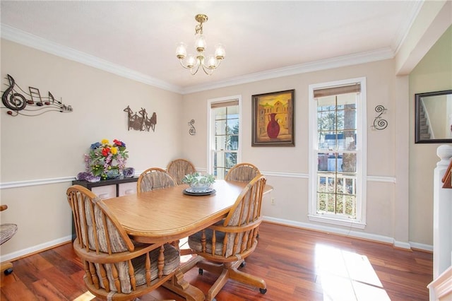 dining space with an inviting chandelier, wood-type flooring, and crown molding