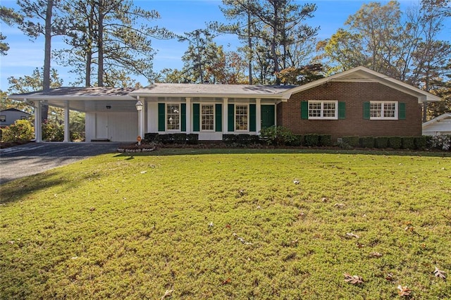 ranch-style home with a front lawn and a carport