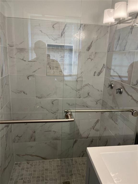 bathroom featuring vanity and a shower with shower door