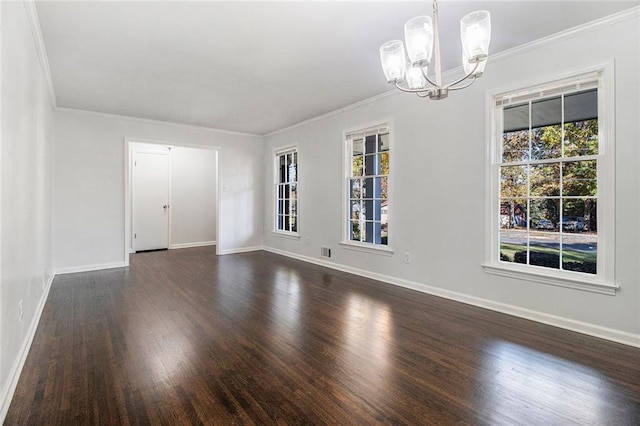 unfurnished room with dark hardwood / wood-style floors, ornamental molding, and an inviting chandelier